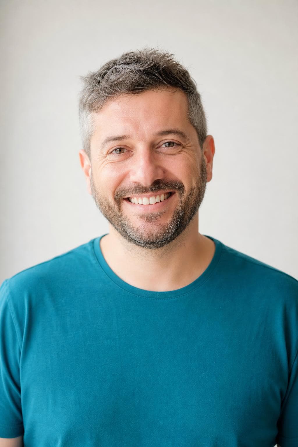 AI profile picture in Facebook style — man in a plain teal t-shirt against an off-white wall in flat daylight